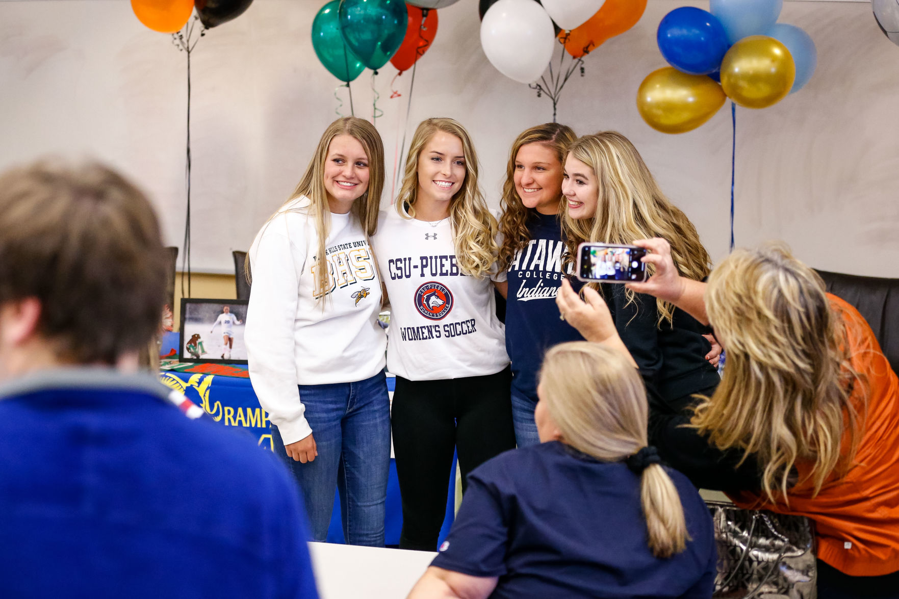 SIGNING DAY: Rampart athletes sign their National Letter of Intent